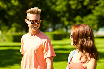 Image showing happy teenage couple walking at summer park