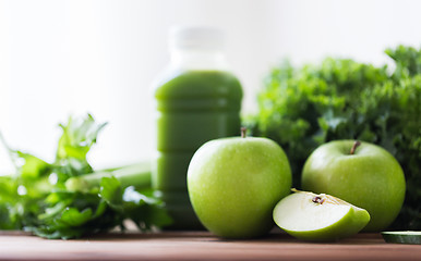 Image showing close up of bottle with green juice and vegetables