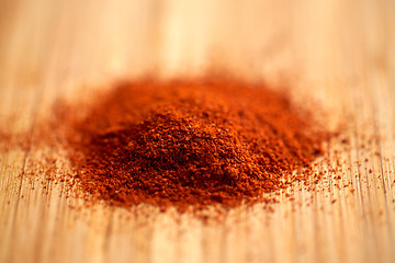 Image showing cayenne pepper or paprika powder on wood