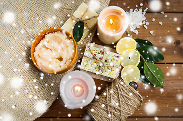 Image showing natural soap and candles on wood