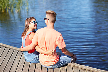 Image showing happy teenage couple hugging on river berth