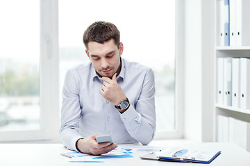 Image showing close up of businessman with smartphone