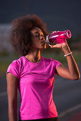 Image showing Portrait of a young african american woman running outdoors