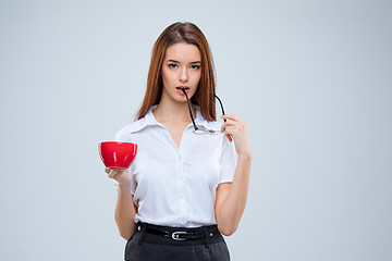 Image showing The young business woman on gray background