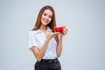 Image showing The young business woman on gray background