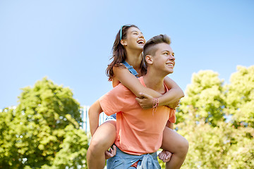 Image showing happy teenage couple having fun at summer park