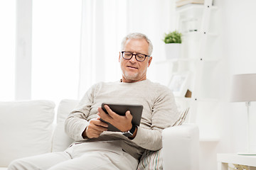 Image showing senior man with tablet pc at home