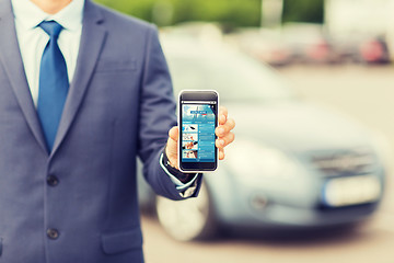 Image showing close up of business man with smartphone and car