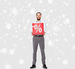 Image showing smiling man with red percentage sign over snow