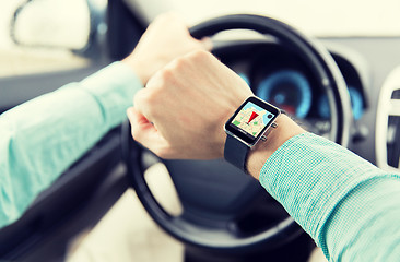 Image showing close up of man driving car with gps on smartwatch
