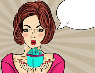 Image showing Surprised pop art  woman that holds a gift in their hands . Comi