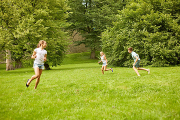 Image showing happy kids running and playing game outdoors