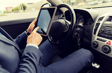 Image showing close up of young man with tablet pc driving car