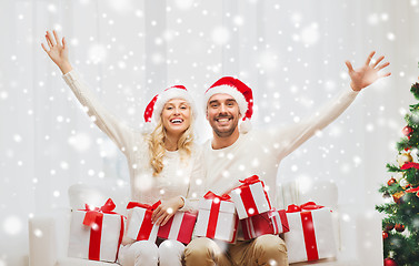 Image showing happy couple at home with christmas gift boxes