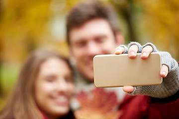 Image showing couple taking selfie by smartphone in autumn park