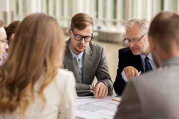 Image showing architects with blueprint and tablet pc at office