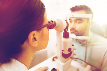 Image showing optician with slit lamp and patient at eye clinic