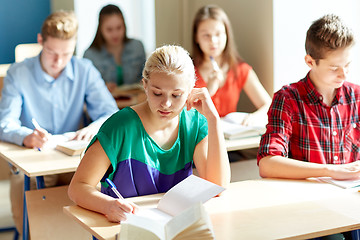 Image showing group of students with books writing school test