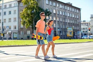 Image showing teenage couple with skateboards on city street