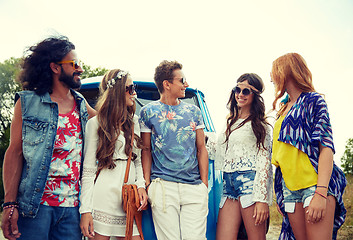 Image showing smiling young hippie friends over minivan car