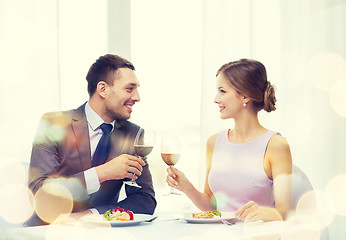 Image showing couple with main course and red wine at restaurant