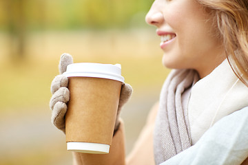 Image showing close up of happy woman with coffee in autumn park