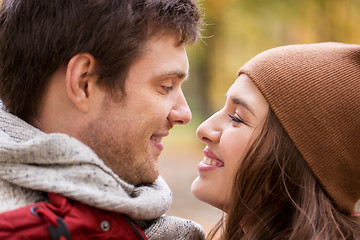 Image showing close up of happy young couple kissing outdoors