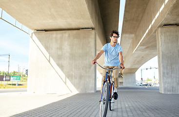 Image showing young hipster man riding fixed gear bike