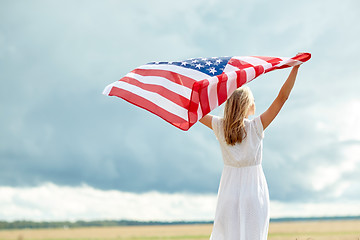 Image showing happy woman with american flag on cereal field