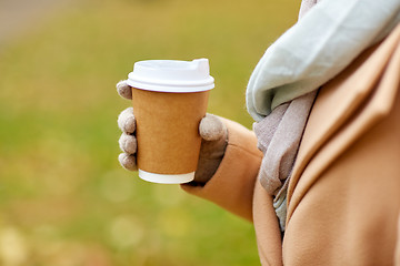 Image showing close up of woman with coffee in autumn park