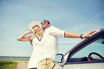 Image showing happy couple hugging near cabriolet car at sea