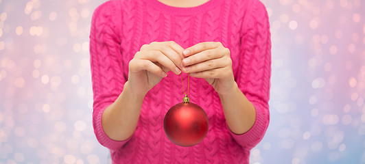 Image showing close up of woman in sweater with christmas ball