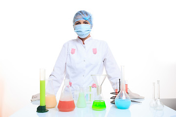 Image showing Woman chemist and chemicals in flasks