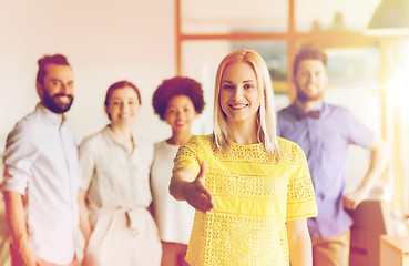 Image showing woman making handshake over creative office team