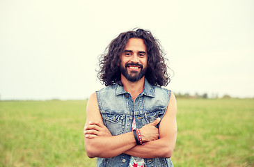 Image showing smiling young hippie man on green field