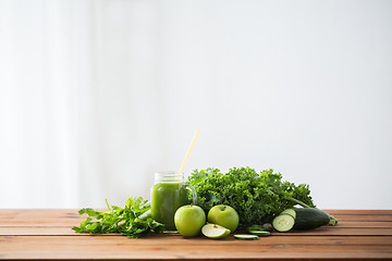 Image showing close up of jug with green juice and vegetables