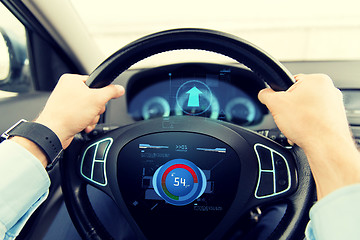 Image showing close up of man driving car with volume level icon