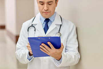 Image showing close up of doctor with clipboard at hospital