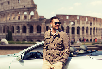 Image showing happy man near cabriolet car over coliseum