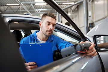 Image showing mechanic man with diagnostic scanner at car shop