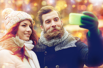 Image showing couple taking selfie with smartphone in old town