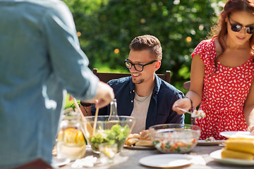 Image showing happy friends having dinner at summer garden party