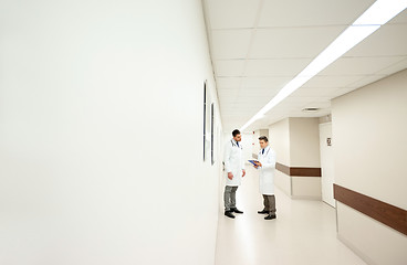 Image showing male doctors with clipboard at hospital corridor