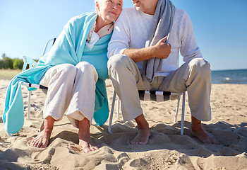 Image showing close up of senior couple sitting on beach chairs