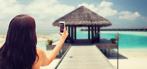 Image showing young woman taking selfie with smartphone