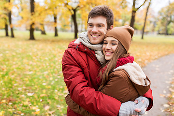 Image showing happy young couple hugging in autumn park