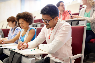 Image showing group of students with notebooks in lecture hall