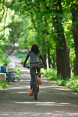 Image showing cyclist woman riding a bicycle in park