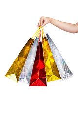 Image showing Womans hand holding colorful shopping bags 