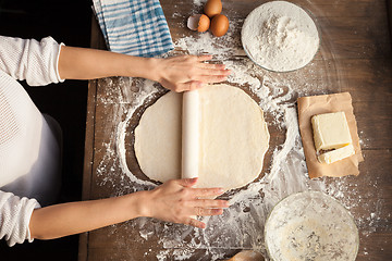 Image showing Female cooking dough.